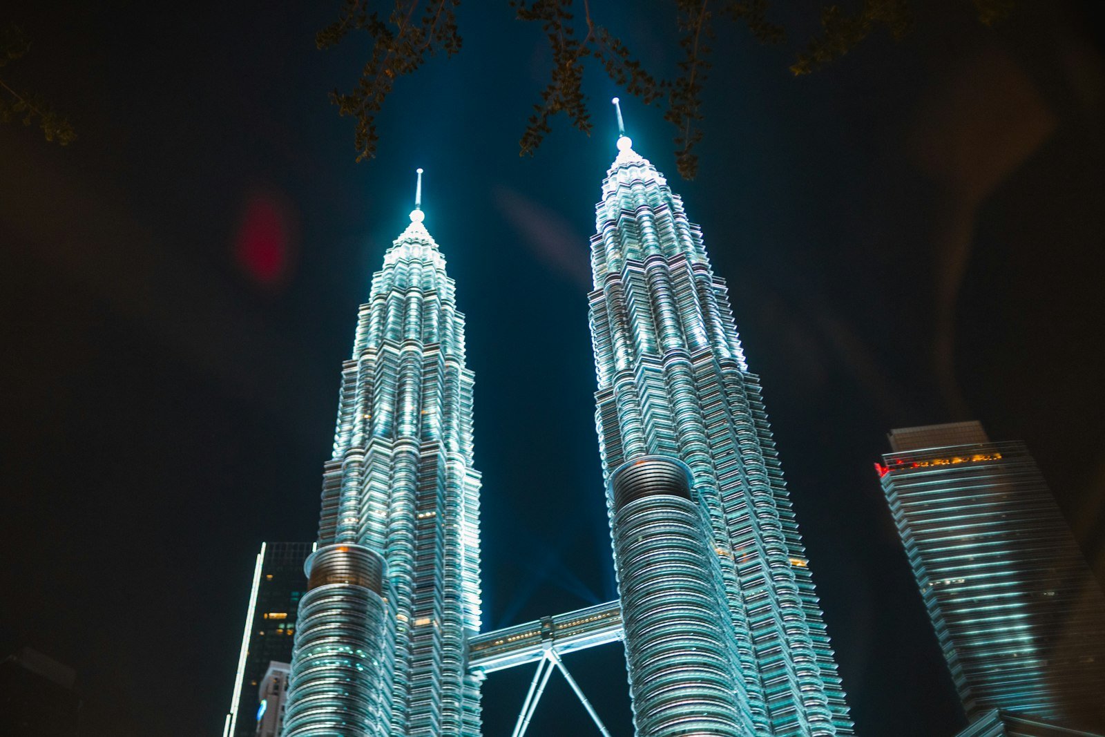 Petronas Twin Towers glowing above Kuala Lumpur at night, Malaysia