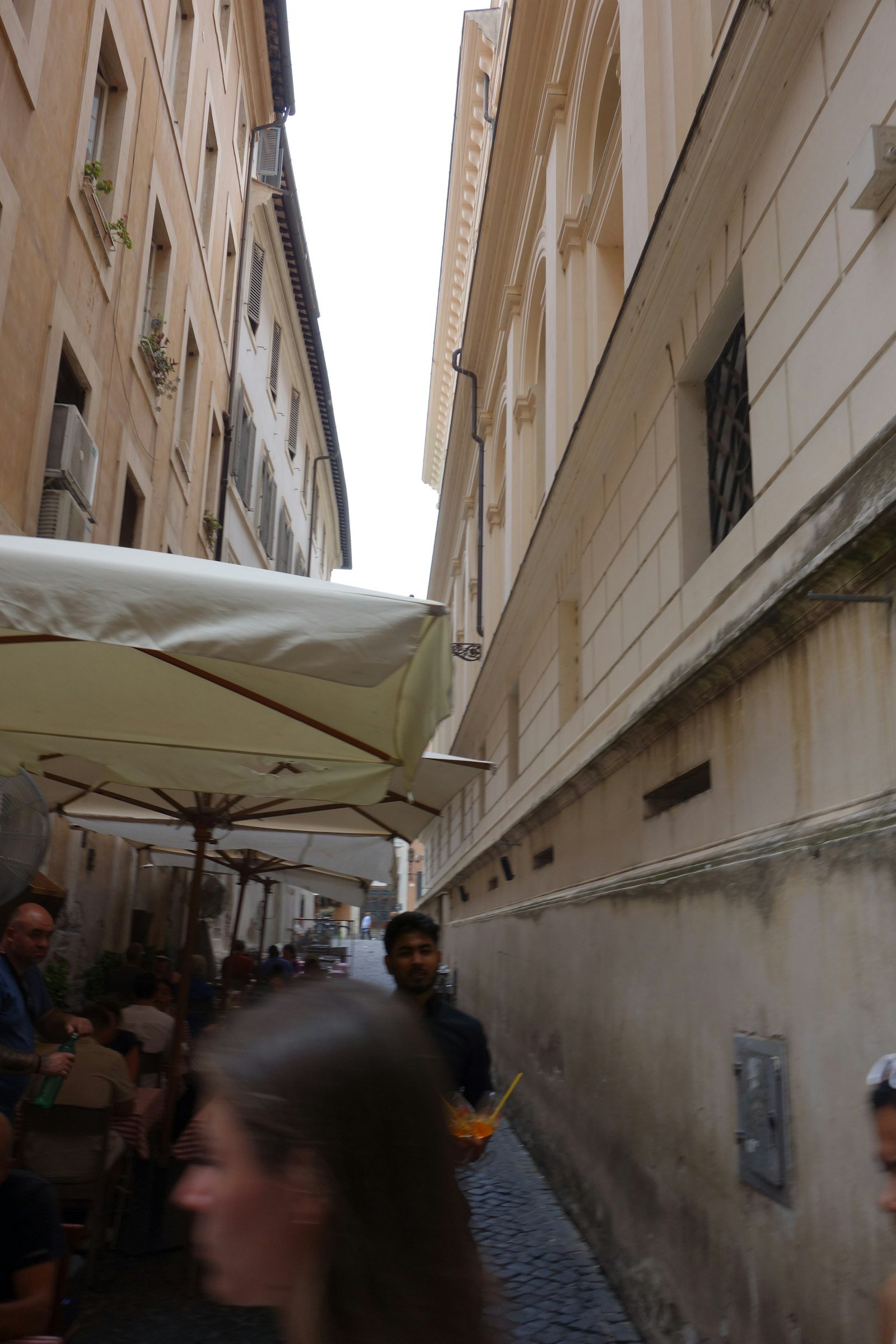 People enjoying an outdoor café on a charming European street