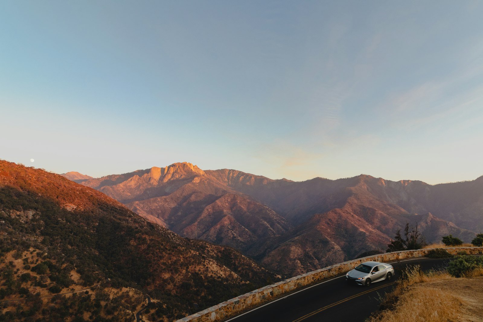 Car travelling through a scenic mountain road