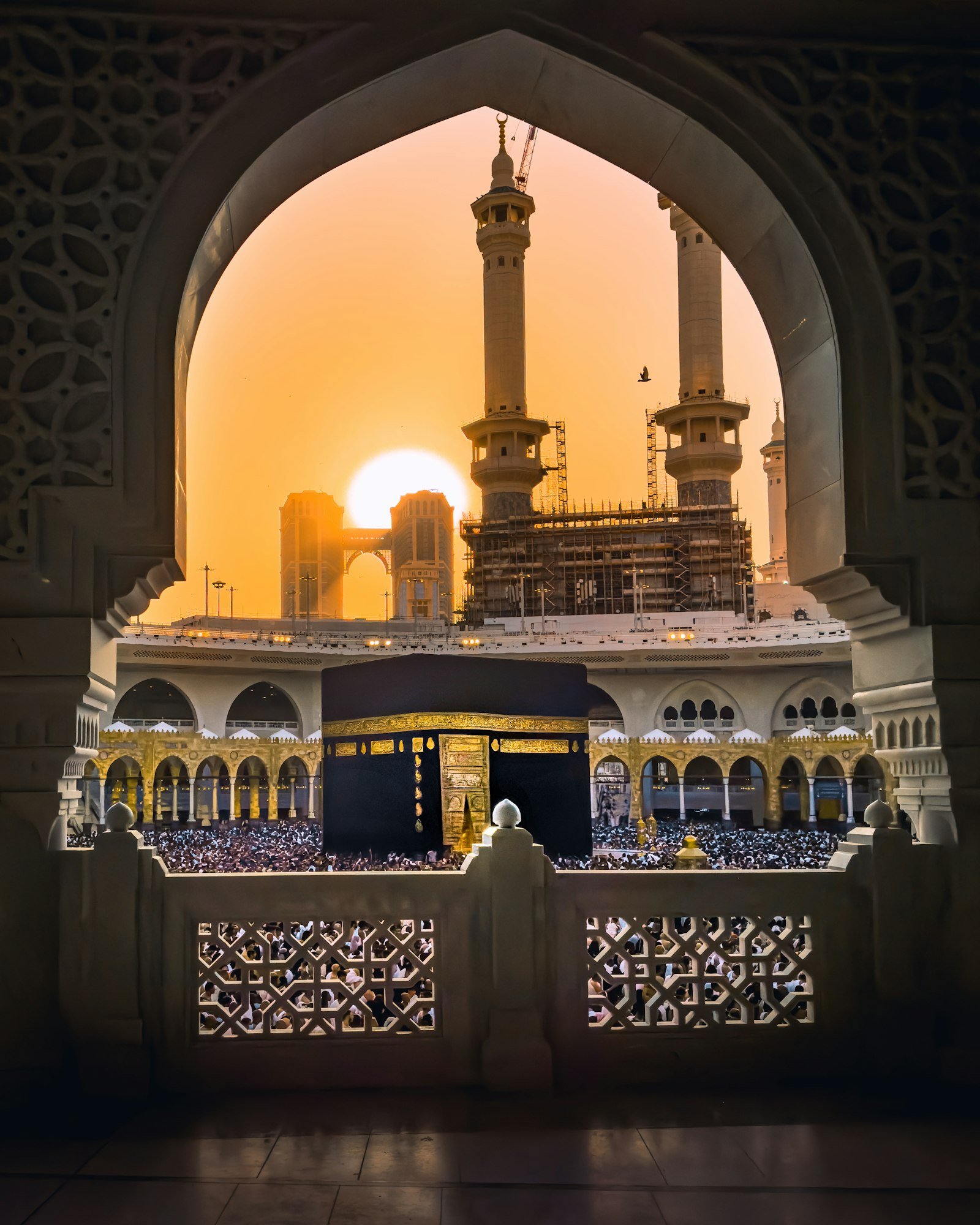 Elegant framed view of the Holy Kaaba through an arch at Masjid al-Haram