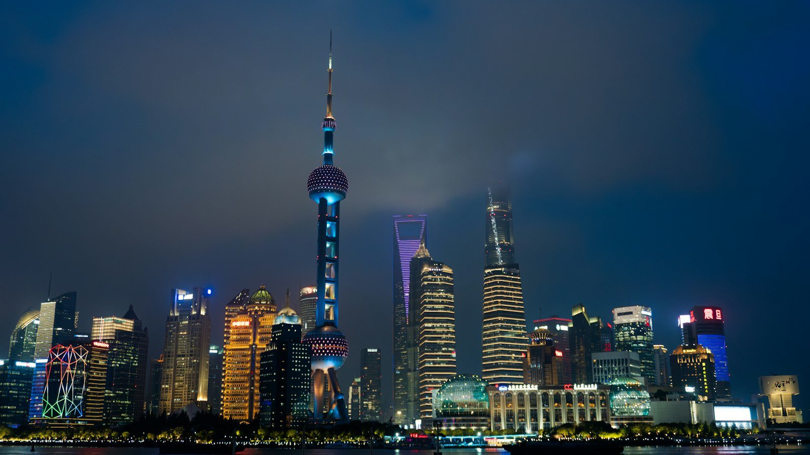 Shanghai skyline and Huangpu River illuminated at night, China