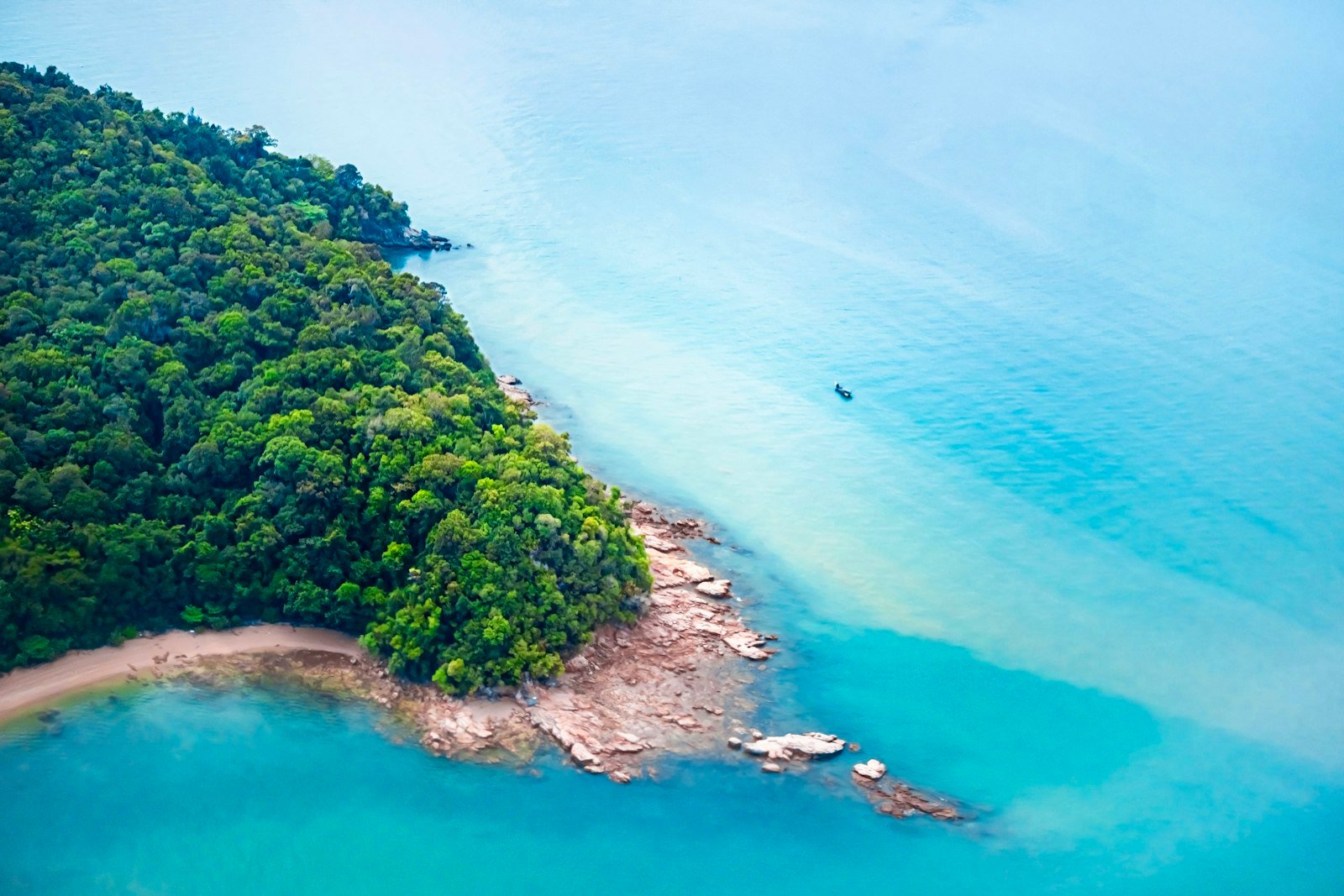 Aerial view of a lush tropical island and turquoise sea in Langkawi, Malaysia
