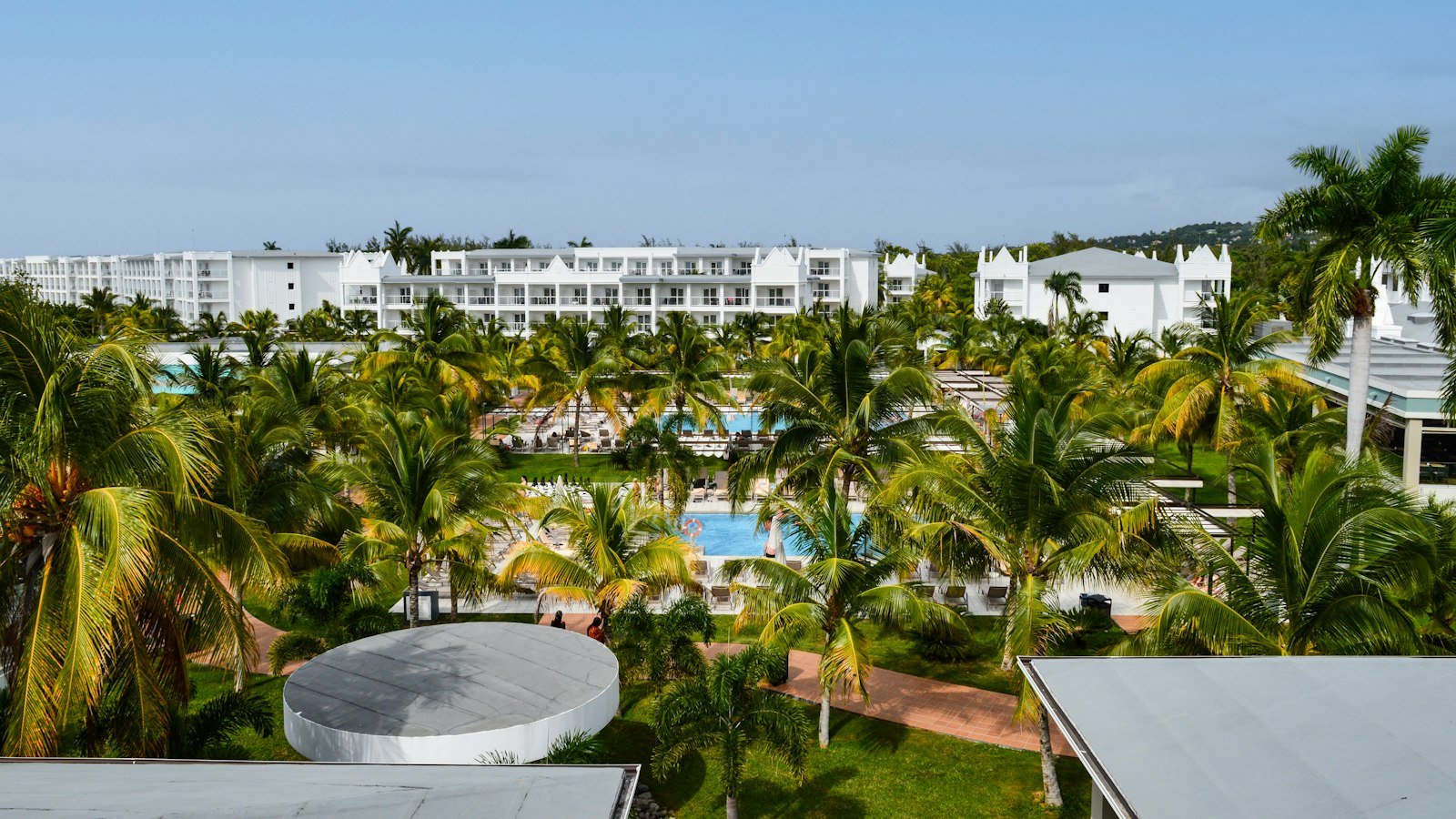 Family-friendly tropical resort with pools and palm trees